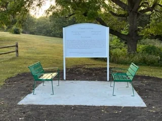 Memorial benches beneath the trees