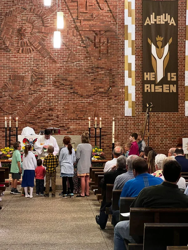 The sanctuary at First Lutheran on Easter morning, with a banner reading “He is risen”
