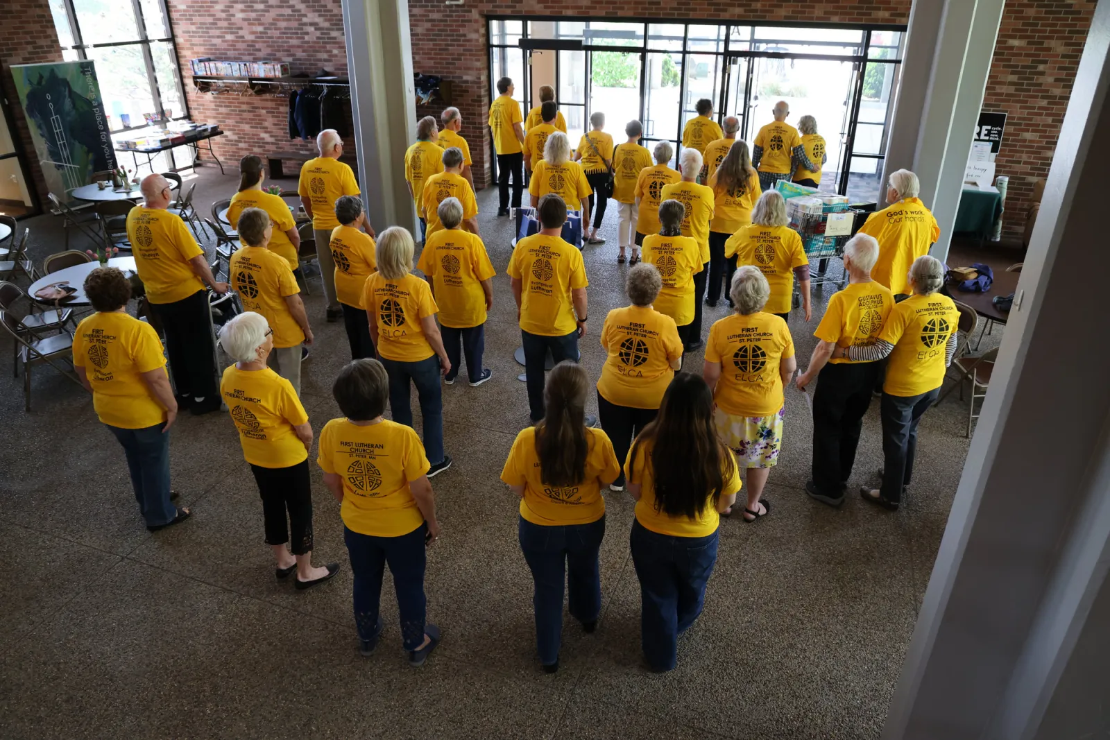Members in matching yellow shirts gathered to serve
