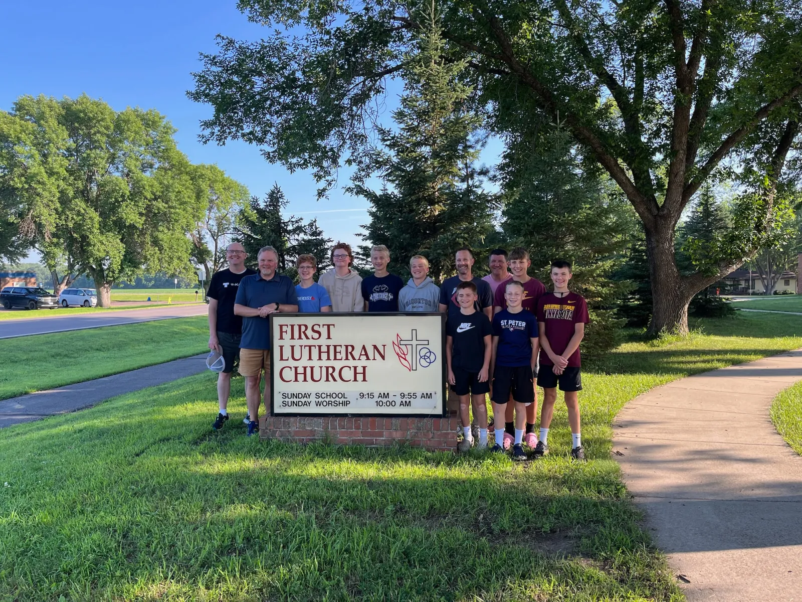 Youth group gathered at the First Lutheran Church sign